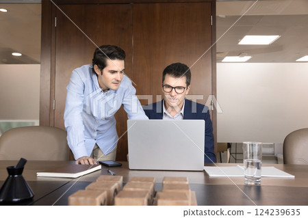 Two workmates reviewing important data, documents, or presentations using laptop Two workmates reviewing important data, documents, or presentations using laptop 124239635