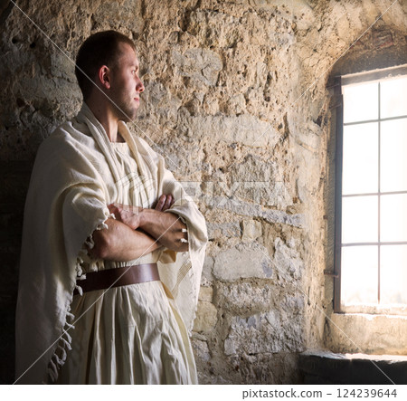 Ancient man at the window 124239644