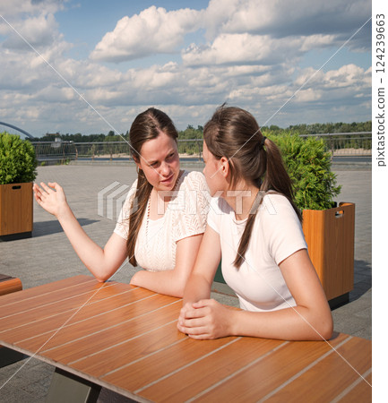 Girls look at people with disapproval Girls look at people with disapproval 124239663