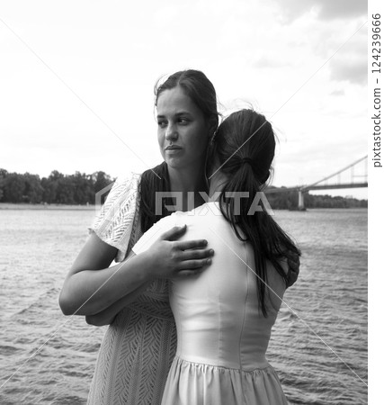 Insincere smile of a hugging girl Insincere smile of a hugging girl 124239666