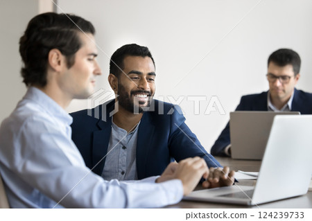 Two colleagues collaborating, reviewing new business platform on laptop 124239733
