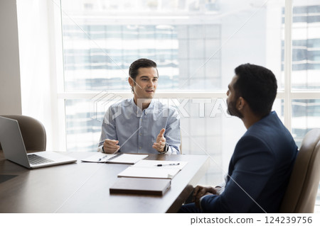 Spaniard man lead formal conversation with Indian businessman 124239756