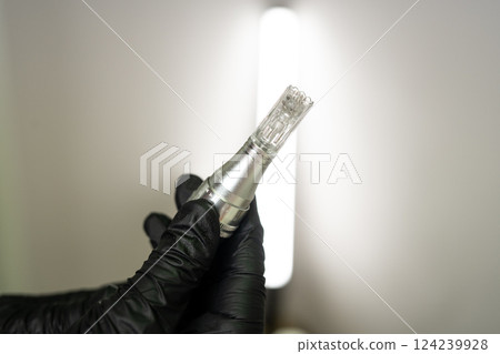 Microneedle RF lifting procedure. A cosmetologist performs a facial rejuvenation procedure on a woman. Hardware cosmetology. 124239928