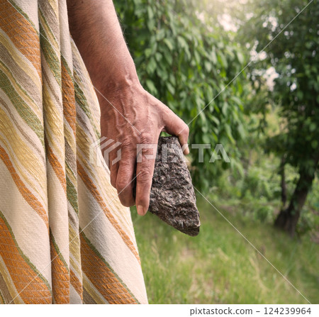 Male hand with big stone 124239964