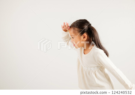 Searching concept. Asian young girl kid looking far away with hand over head at studio shot isolated on white background, Portrait of Happy kindergarten child looking at distance with eyes shaded 124240532