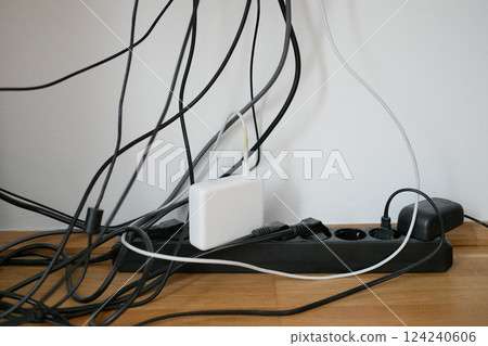 Lots of wires in a socket at work. Cabling chaos. Concept of the problem of saving space and aesthetics Lots of wires in a socket at work. Cabling chaos. Concept of the problem of saving space and aesthetics 124240606