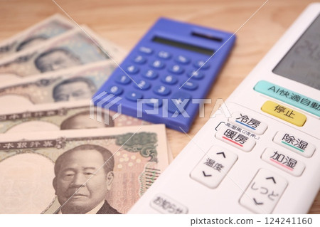 Air conditioner remote control, calculator and banknotes - Image of air conditioner electricity bill 124241160