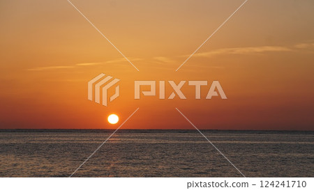 Relax and unwind with a sunset view from the beach 124241710