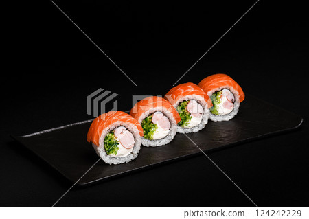 Delicious Fresh Salmon Sushi Rolls Presenting Exquisitely on a Black Background Delicious Fresh Salmon Sushi Rolls Presenting Exquisitely on a Black Background 124242229