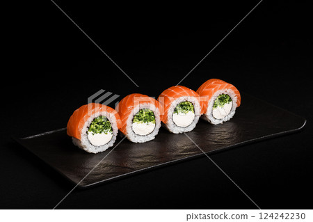 Delicious Fresh Salmon Sushi Rolls Presenting Exquisitely on a Black Background 124242230