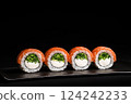 Delicious Fresh Salmon Sushi Rolls Presenting Exquisitely on a Black Background 124242233