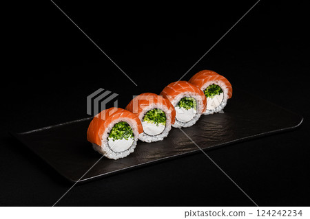 Delicious Fresh Salmon Sushi Rolls Presenting Exquisitely on a Black Background 124242234