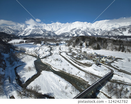 A magnificent view of the Hakuba mountain range and Hakuba village from Nodaira, Hakuba village, Nagano prefecture (aerial shot by drone) 124242782