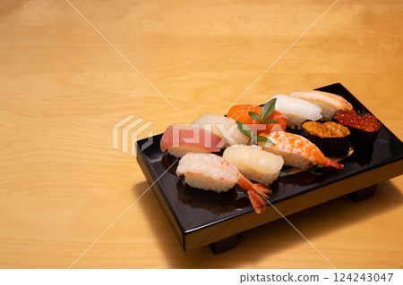 Beautifully presented sushi platter on a black lacquerware dish 124243047