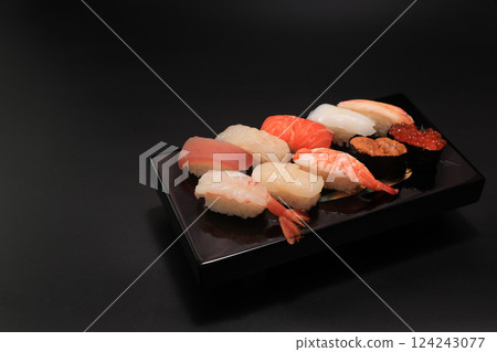 Beautifully presented sushi platter on a black lacquerware dish Beautifully presented sushi platter on a black lacquerware dish 124243077