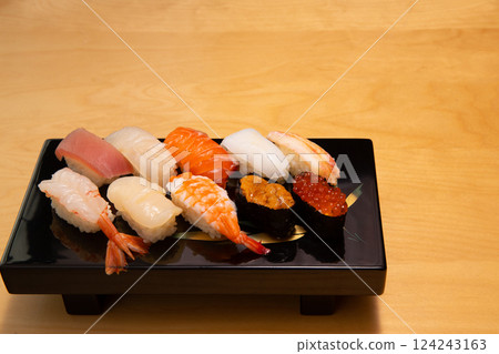 Beautifully presented sushi platter on a black lacquerware dish Beautifully presented sushi platter on a black lacquerware dish 124243163
