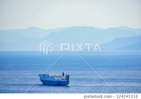 A large cargo ship sailing through the blue Pacific Ocean 124245318