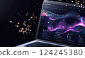 Laptop screen displaying a digital interface with vibrant, multicolored waveforms resembling data visualizations 124245380
