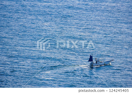 Small fishing boats fishing Small fishing boats fishing 124245405