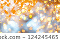 Bright bokeh effect with circular light spots in warm yellow, orange, and cool white tones.	 124245465