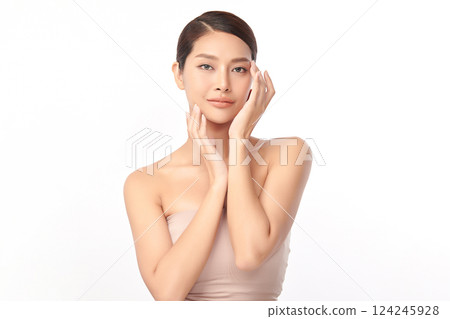 A beautiful young Asian woman with clean, fresh skin against a white background. Skincare, facial treatment, cosmetology, beauty, and spa. An elegant portrait of an Asian woman. 124245928