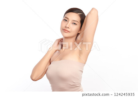 Beautiful Young Asian woman Raises her hands to Showcase clean and hygienic underarms Against a white background, Smooth armpit cleanliness and protection concept 124245935
