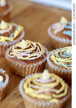 Banana muffins decorated by a child with chocolate pens Banana muffins decorated by a child with chocolate pens 124246269