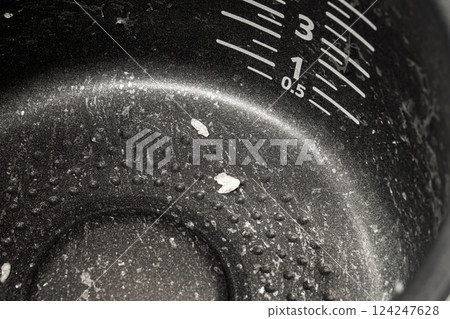 A close-up of the inner pot of a rice cooker shows how much effort housework requires A close-up of the inner pot of a rice cooker shows how much effort housework requires 124247628