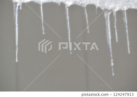 Drops falling from icicles Drops falling from icicles 124247913