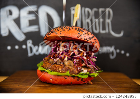 Fresh colorful vegan burgers with vegetables on counter at summer local food market - close up view. Outdoor cooking, gastronomy, vegetarian, street food concept 124248953