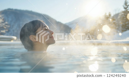 A woman refreshes herself in the open-air hot spring first thing in the morning A woman refreshes herself in the open-air hot spring first thing in the morning 124249240