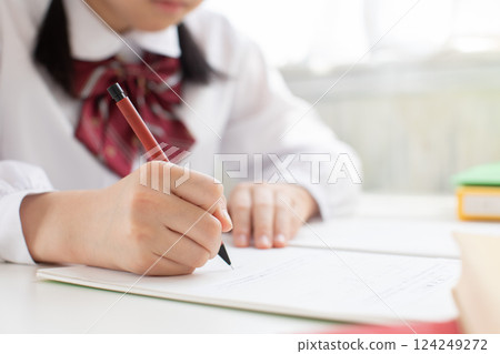 Female junior high school student studying using a notebook 124249272