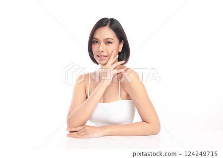 A beautiful young Asian woman with clean, fresh skin against a white background. Skincare, facial treatment, cosmetology, beauty, and spa. An elegant portrait of an Asian woman. 124249715