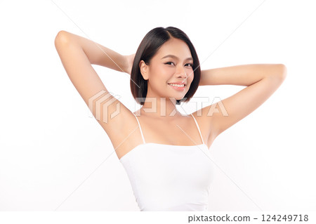 Beautiful Young Asian woman Raises her hands to Showcase clean and hygienic underarms Against a white background, Smooth armpit cleanliness and protection concept 124249718