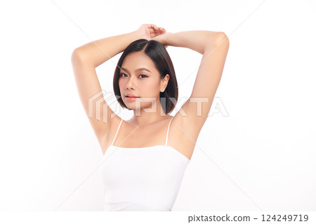 Beautiful Young Asian woman Raises her hands to Showcase clean and hygienic underarms Against a white background, Smooth armpit cleanliness and protection concept 124249719