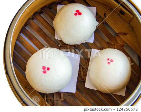 Top view of Three mini steamed pork bao in basket , focus selective 124250578