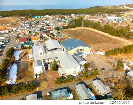Aerial view of Esashi Town's Esashi Kita Elementary and Junior High School in early spring in Esashi Town, Hokkaido 124251025