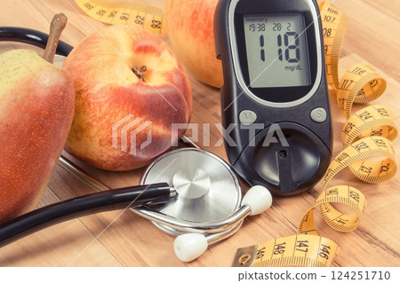 Glucometer with sugar level and fresh fruits. Healthy lifestyle and nutrition during diabetes 124251710