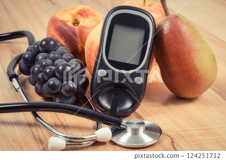 Glucose meter and fresh fruits. Healthy lifestyle and nutrition during diabetes Glucose meter and fresh fruits. Healthy lifestyle and nutrition during diabetes 124251712