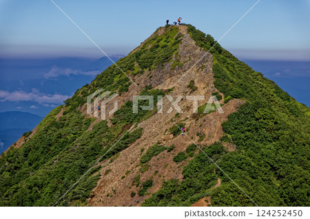 Climbers standing on the peak of the hosta tree seen from Mount Gongen in the Yatsugatake mountain range 124252450