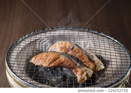 Delicious salmon grilled on a charcoal grill 124252750