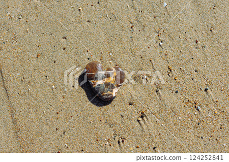 Sea stone in the shape of a heart. Sea stone on the sand. Mediterranean beach. Sea stone in the shape of a heart. Sea stone on the sand. Mediterranean beach. 124252841