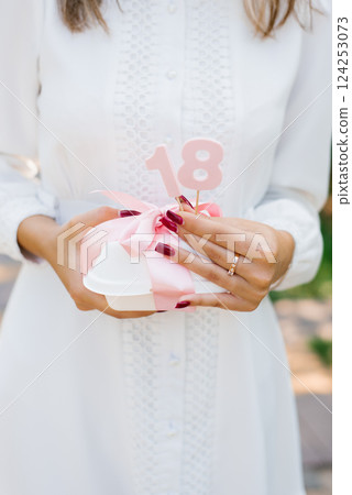Girl Holding Gift For 18th Birthday Girl Holding Gift For 18th Birthday 124253073