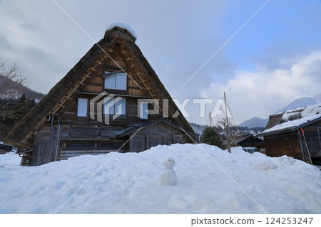 白川鄉合掌村的景色,合掌屋前擺放著雪人 白川鄉合掌村的景色,合掌屋前擺放著雪人 124253247