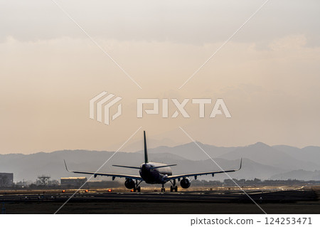 Sendai Airport at dusk, airplane taking off, Natori City, Miyagi Prefecture Sendai Airport at dusk, airplane taking off, Natori City, Miyagi Prefecture 124253471