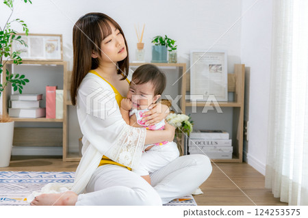 Mom comforting a crying baby 124253575