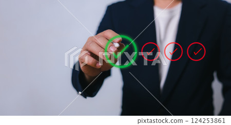 Businessman write or tick correct mark to approve document or project, Application for certificate, Quality management and assurance, Business certification, Pass inspection, Accept approved, QA, QC. 124253861
