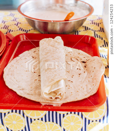 Food Traditional Large Quesillo served on table. Nicaraguan cheese made and served on the table. Traditional cheese with pickled onion and wrapped tortilla, Traditional Nicaraguan Quesillo Food Traditional Large Quesillo served on table. Nicaraguan cheese made and served on the table. Traditional cheese with pickled onion and wrapped tortilla, Traditional Nicaraguan Quesillo 124254253
