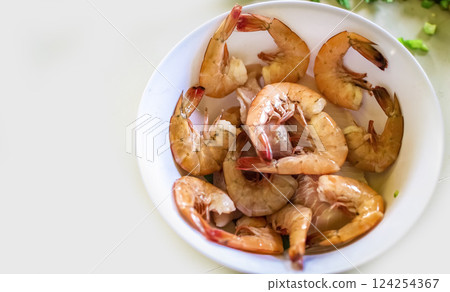 High angle view of raw shrimp on white table, raw shrimp in bowl on white table High angle view of raw shrimp on white table, raw shrimp in bowl on white table 124254367