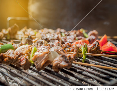Roast beef skewers on a grill, Roast beef skewers grilling on a grill, Roast beef concept 124254386